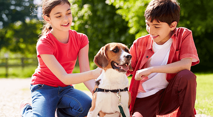 two kids petting dog